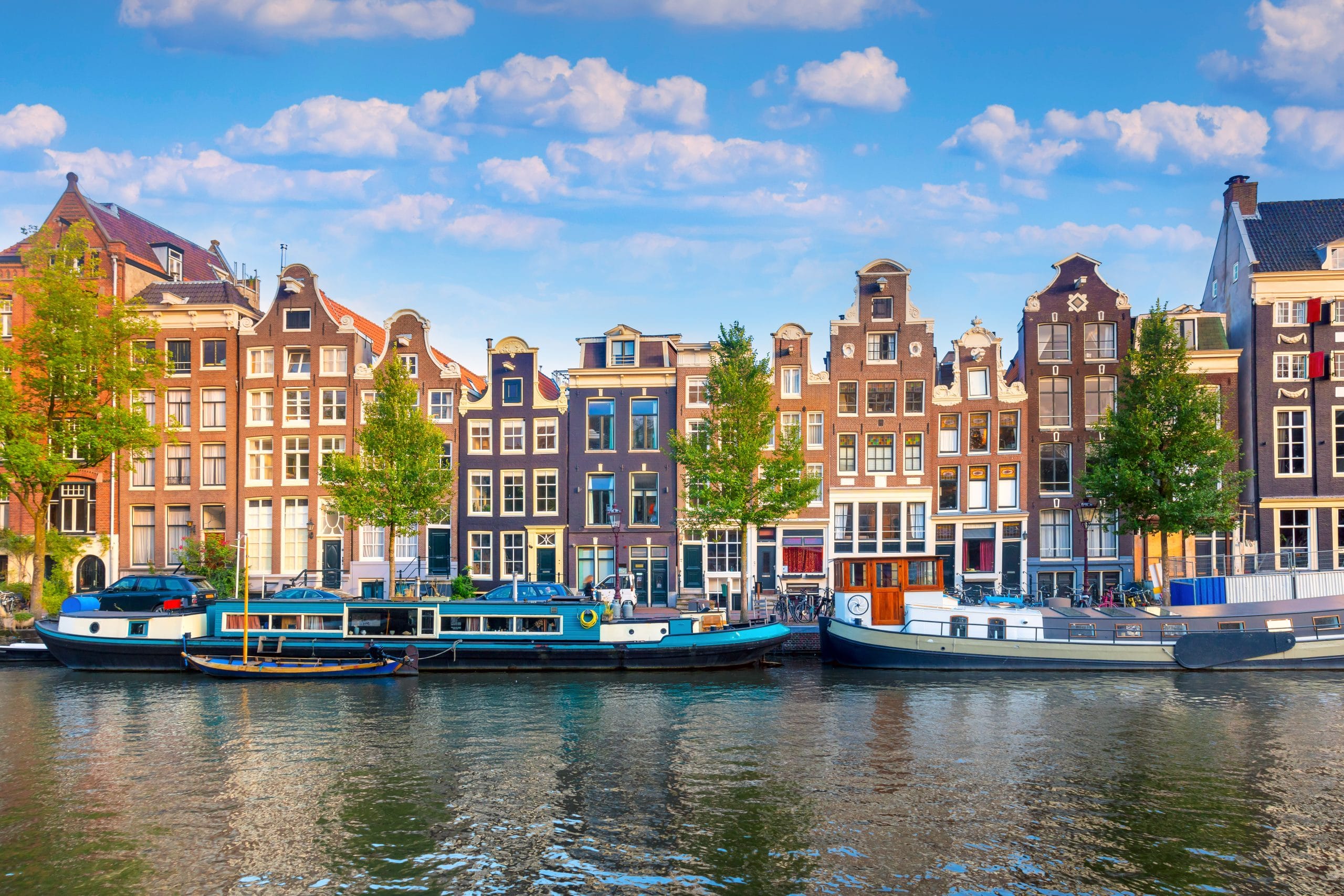Amsterdam. Panoramic view of the historic city center of Amsterdam. Traditional houses and bridges of Amsterdam. An early quiet morning. Europe, Netherlands, Holland, Amsterdam.